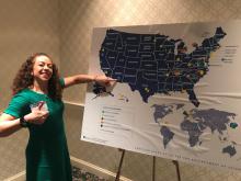 Dr. Mónica Ramírez-Andreotta pointing to Arizona on a map of the United States showing where different types of public engagement with science occur at the 185th AAAS Annual Meeting in Washington, D.C.  