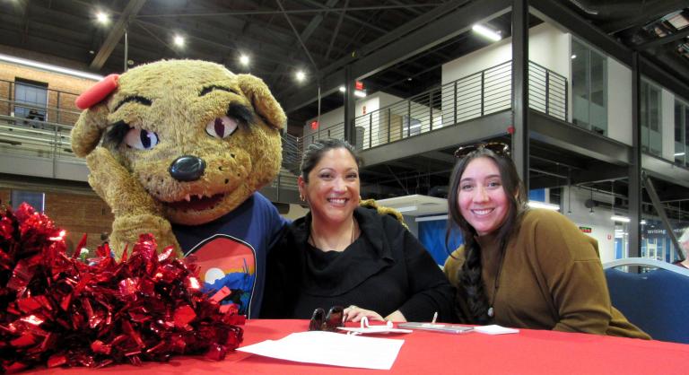 Wildcat mascot poses with employees at awards event