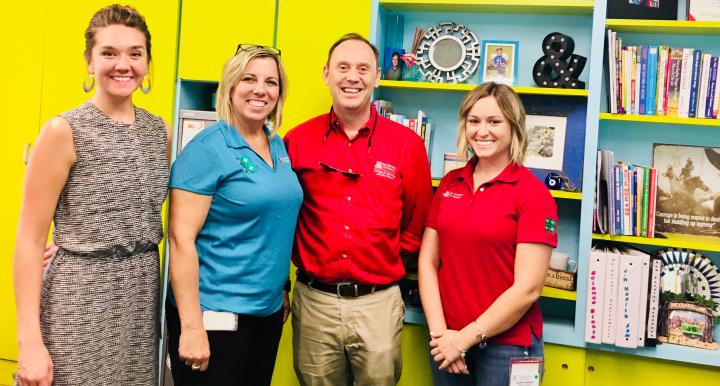 Kim Christman, second from left, and members of her Maricopa County Cooperative Extension 4-H team, Hannah Hanson and Taylor Hubbard, with UA Vice President for Agriculture, Life and Veterinary Sciences, and Cooperative Extension Shane Burgess.