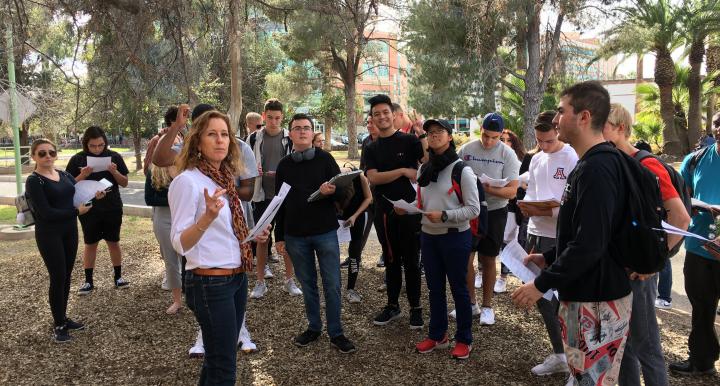 Mullins leading her Sustainable Nutrition and Food Systems class through a tour of edible trees on campus.
