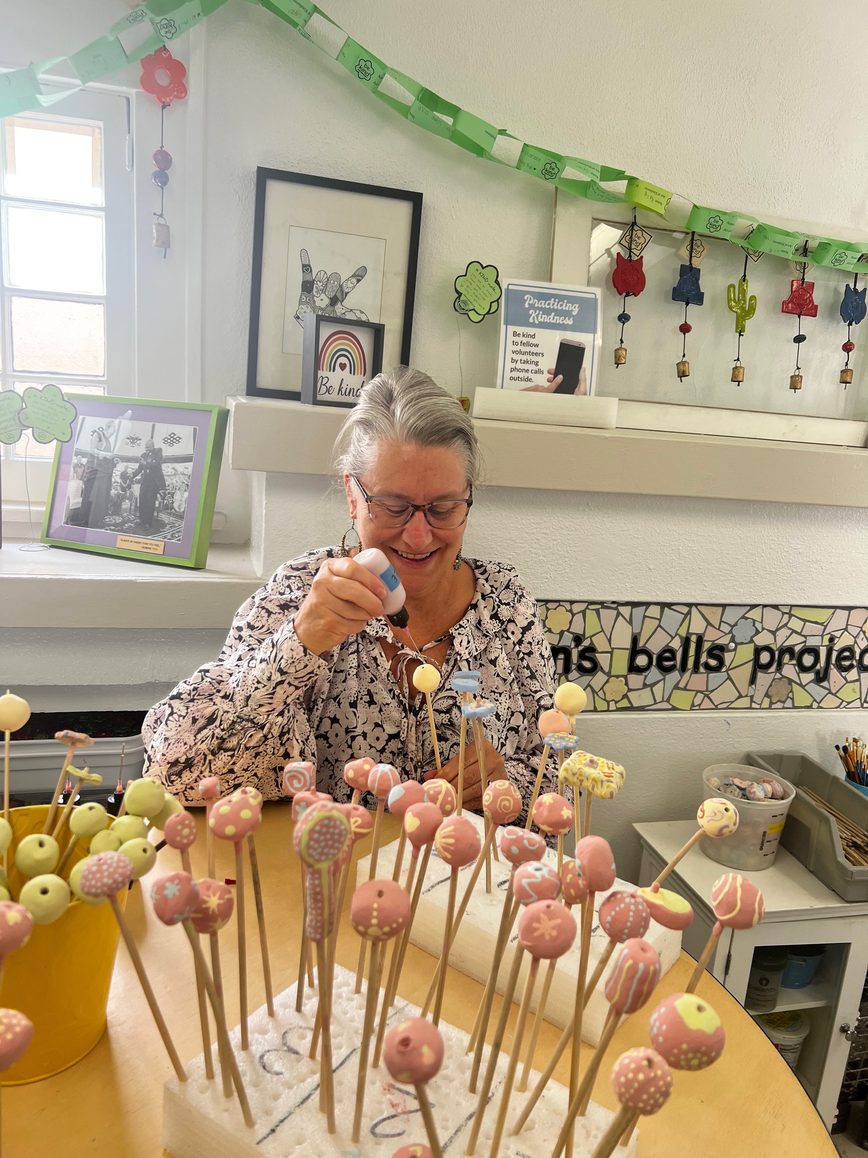 woman paints bell