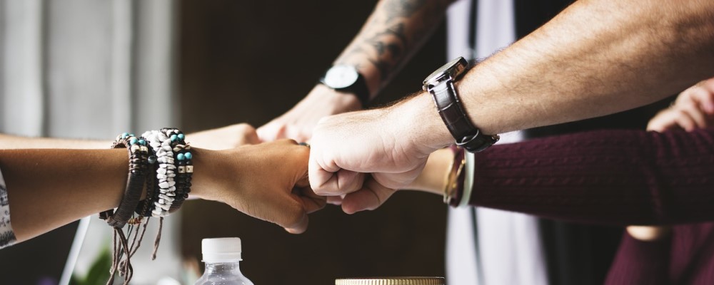 Diverse hands giving a fistbump