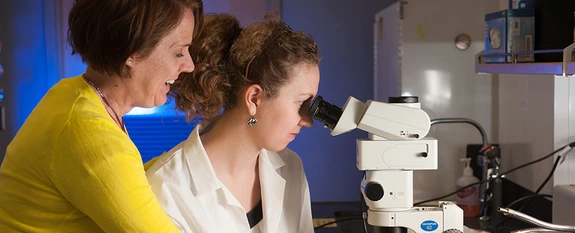 Dr. Monica Schmidt, associate professor of Plant Sciences, with a student in a BIO5 lab.