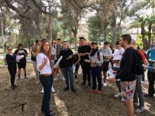 Mullins leading her Sustainable Nutrition and Food Systems class through a tour of edible trees on campus.